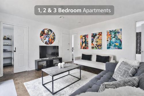 a living room with a couch and a table at 250 METERS to METRO BERRI UQAM - Spacious fully equipped APARTMENTS - 1 FREE PARKING per unit - in-unit Washer & Dryer - fully stocked KITCHEN - WORKSPACE PROVIDED - FAST WIFI - 5 minute walk to the FAMOUS ST CATHERINE & ST DENIS STREET in Montréal