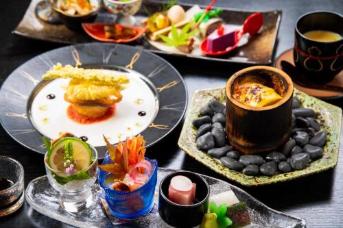 a table with plates of food and a cup of coffee at Tsukasa Ryokan in Saga