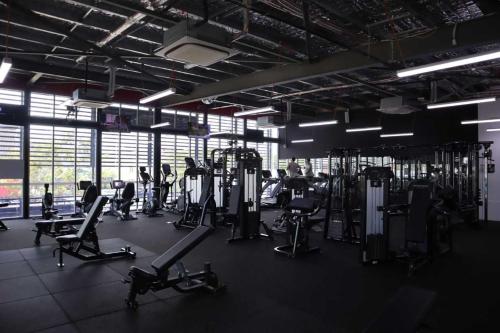 a gym with several treadmills and machines in it at Global Backpackers Youth Hostel in Cairns