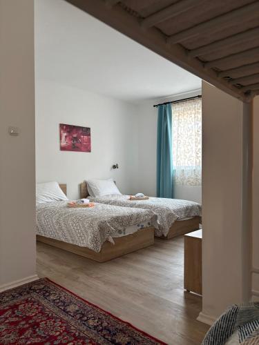 a bedroom with two beds and a window at Hotel VIVA in Sofia