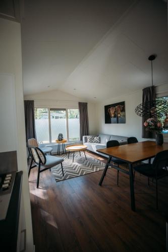 a living room with a couch and a table at Holiday Home Maridu Ayla in Arnhem