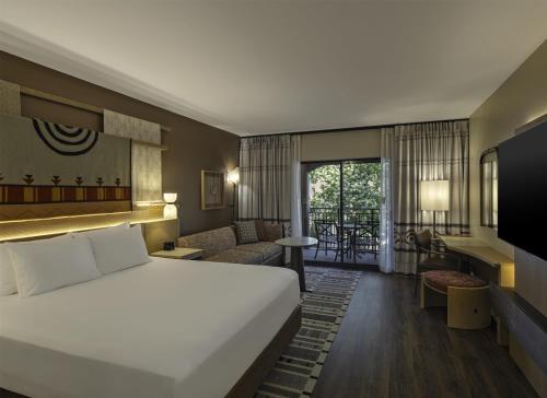 a hotel room with a bed and a living room at Hyatt Regency Tamaya South Santa Fe in Santa Ana Pueblo
