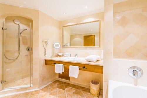 a bathroom with a sink and a shower at Hotel und Landgasthof Altwirt in Großhartpenning
