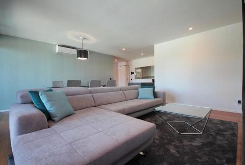 a living room with a couch and a table at Astro Madeira Apartments in Funchal