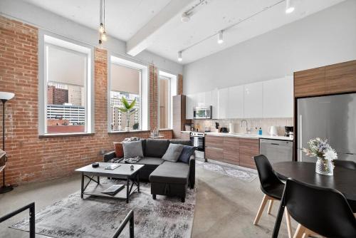 a living room with a couch and a table at Beautiful Downtown Apartment with Pool, Laundry, Parking in Dallas