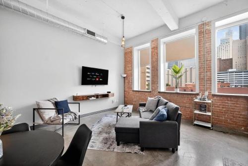 a living room with a couch and chairs and a tv at Beautiful Downtown Apartment with Pool, Laundry, Parking in Dallas