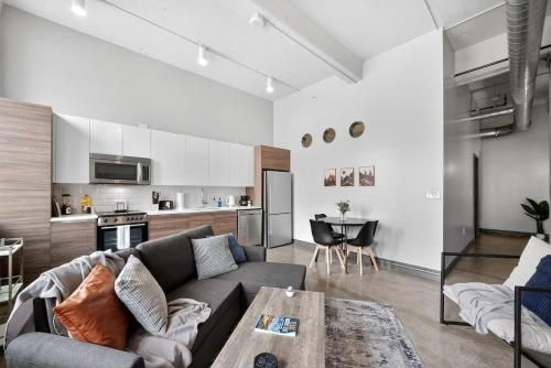 a living room with a couch and a table at Beautiful Downtown Apartment with Pool, Laundry, Parking in Dallas