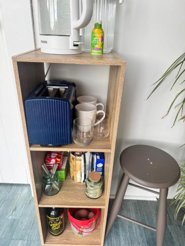 a shelf with a coffee maker and a stool at Harbourview Hideaway in Riverton