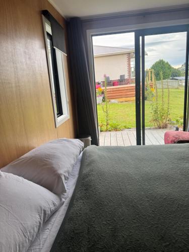 a bedroom with a bed and a sliding glass door at Harbourview Hideaway in Riverton