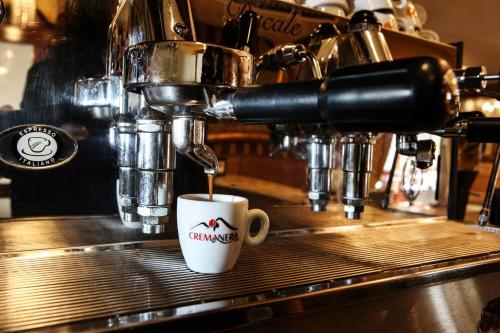 a coffee cup sitting on top of a bar at Hotel Max in Aversa