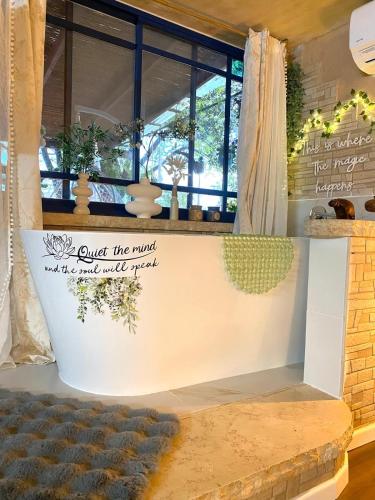 a table with a sign that reads quit the world and find your peace at Boho B&B in Amnon