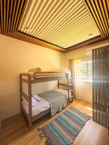 a bedroom with bunk beds in a room at Lakaz Riviere Banane in Trèfles