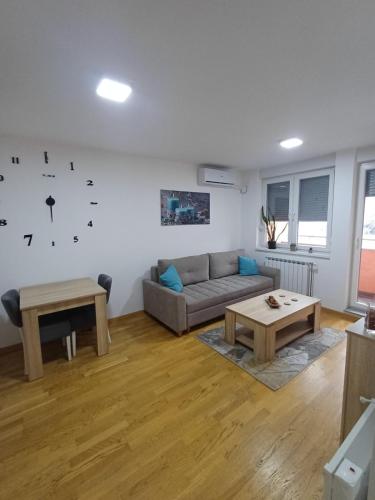 a living room with a couch and a table at Apartman MD in Lukavica