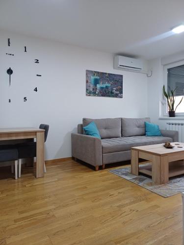 a living room with a couch and a table at Apartman MD in Lukavica