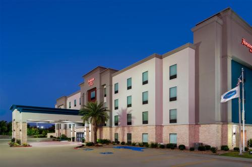 an image of a hotel with a gas station at Hampton Inn Lake Charles in Lake Charles