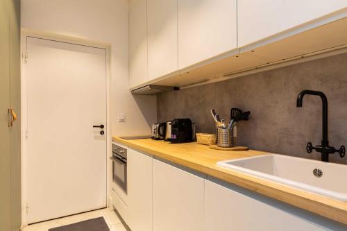 a kitchen with a sink and a counter top at Cosy studio - 2P - Bellecour in Lyon