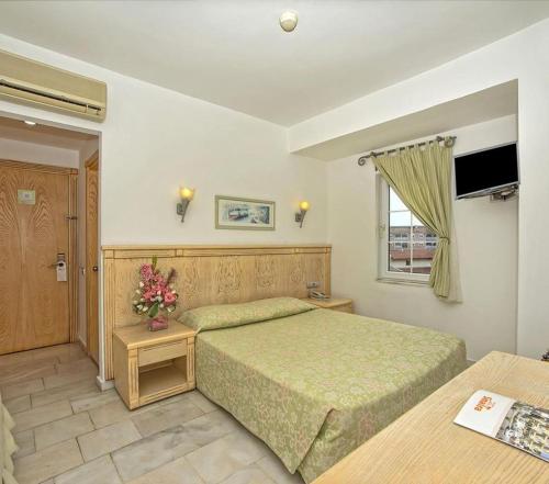 a bedroom with two beds and a window at Hotel Sinatra - All Inclusive in Kemer