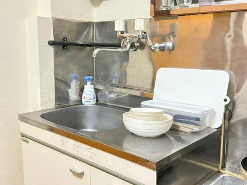 a kitchen sink with a bowl and a mixer at Nogata RelaxingHome E2 in Tokyo