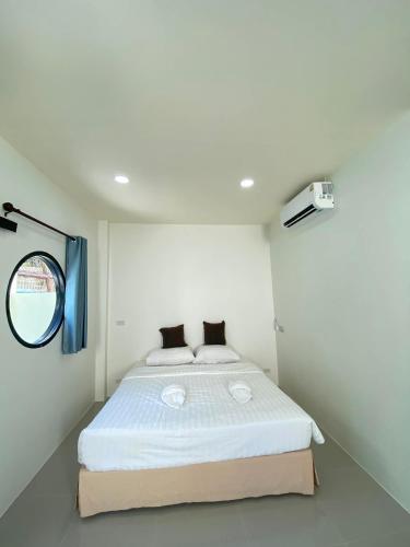 a bedroom with a large white bed in a room at Lantara resort in Ko Lanta