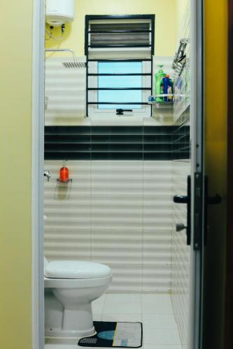 a bathroom with a toilet and a glass wall at Eternal shine serenity in Munyonyo