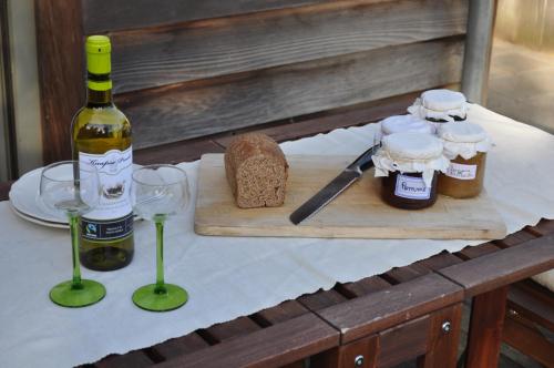 a table with a bottle of wine and two glasses at B&B L'Eau Claire in La Hulpe