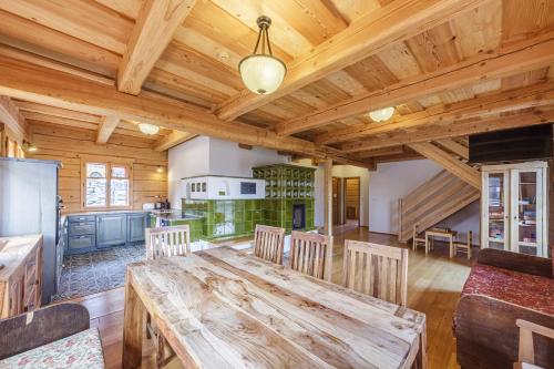 a large dining room with a wooden table and chairs at Roubenka Nové Hutě in Nové Hutě