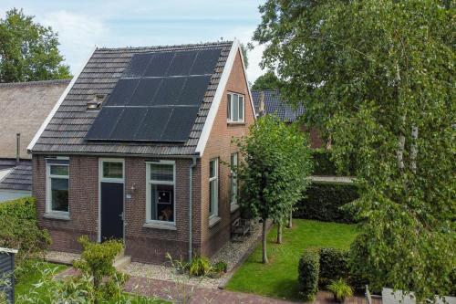 a house with solar panels on the roof at Guesthouse de Bovenboer in Nijeveen