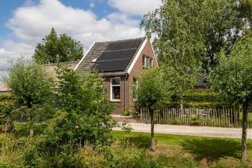 a house with solar panels on the roof at Guesthouse de Bovenboer in Nijeveen
