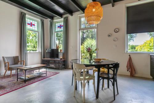 a dining room with a table and chairs at Guesthouse de Bovenboer in Nijeveen
