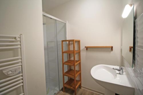 a bathroom with a sink and a glass shower at Gîte 87G7452 in Saint-Mathieu