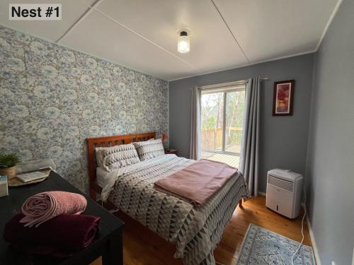 a bedroom with a bed and a window at Grampians Nest in Halls Gap