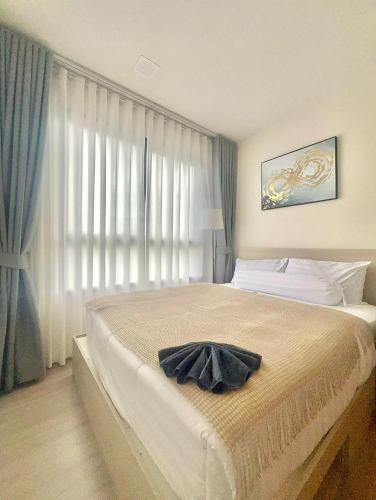 a bedroom with a large bed with a window at Dcondo reef 99 in Kathu