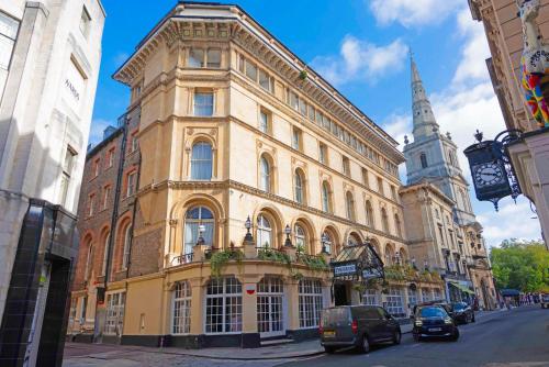 a large building on a city street with a church at The Grand Bristol By Sunday in Bristol