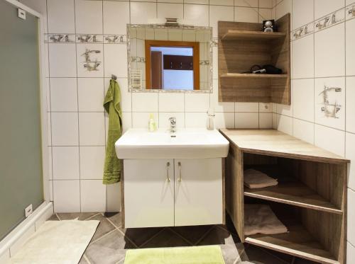 a bathroom with a sink and a mirror at Wittinghof in Julbach