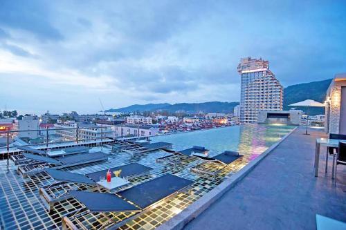 a swimming pool on top of a building at The Gig Hotel in Patong Beach