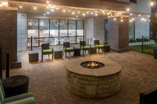 a patio with a fire pit in the middle of a building at Home2 Suites By Hilton Dallas Grand Prairie in Grand Prairie