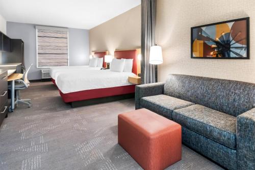 a hotel room with a bed and a couch at Home2 Suites By Hilton Dallas Grand Prairie in Grand Prairie