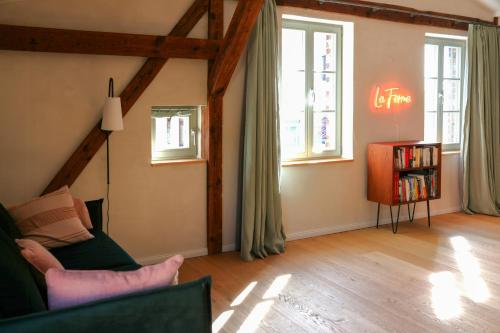 a living room with a couch and some windows at Idyllic Hideaway In The Countryside in Marienwerder