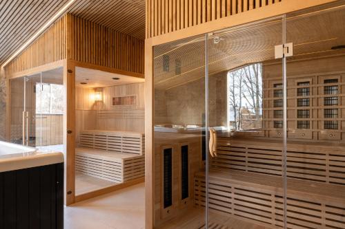 a room with a glass shower in a kitchen at Apartamenty Krupówki 20 in Zakopane