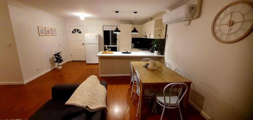 a kitchen and living room with a table and a counter at Hunter Valley Family & Pet friendly Self Contained Accommodation in Mulbring