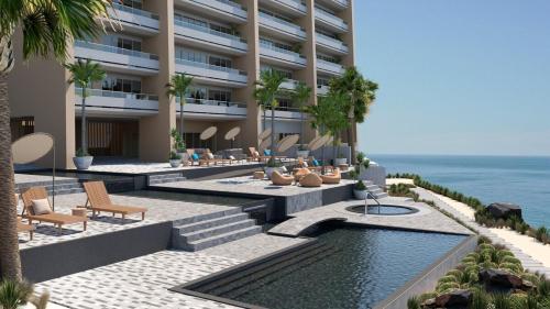 an external view of a hotel with a swimming pool at Hermoso apartamento en la playa in Tijuana