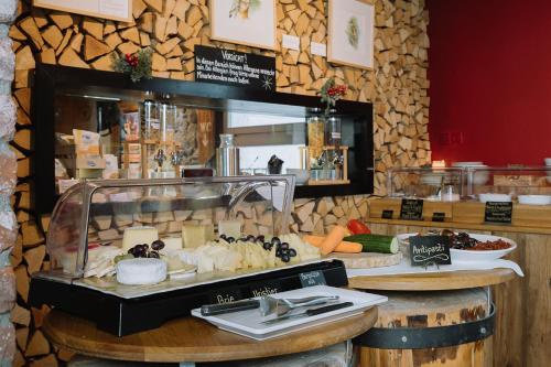 a bakery with a display of food on a counter at Alpenblick Weggis - Panorama & Alpen Chic Hotel in Weggis