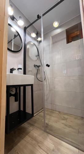 a bathroom with a sink and a shower at Chata Sauna Sosna in Litmanová