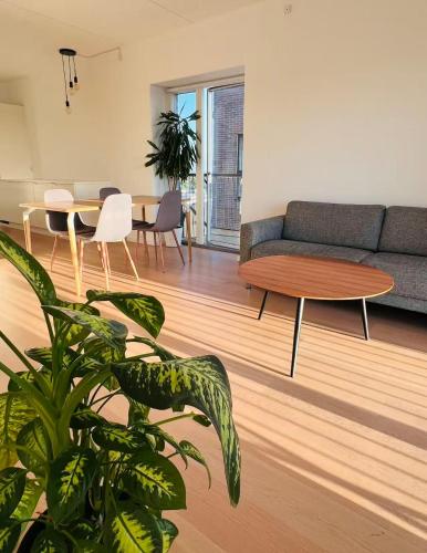 a living room with a couch and a table at Ama Hyg Atelier Copenhagen Royal Arena 2 Bedrooms Apartment in Copenhagen