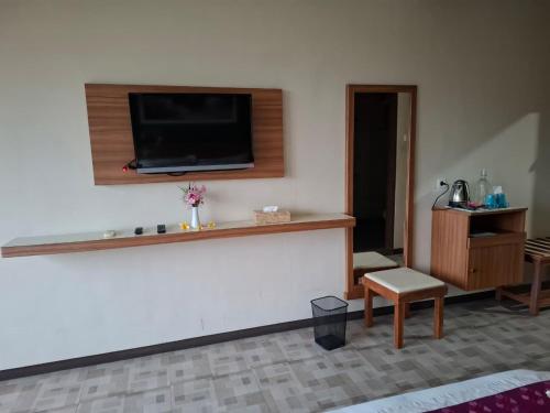 a living room with a flat screen tv on a wall at Bella Vista Premium Homestay in Banyuwangi