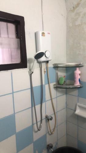 a shower in the corner of a bathroom at MeeboonHome in San Kamphaeng