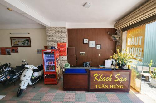 a store with a scooter parked next to a counter at Tuấn Hưng Hotel HCM in Ho Chi Minh City