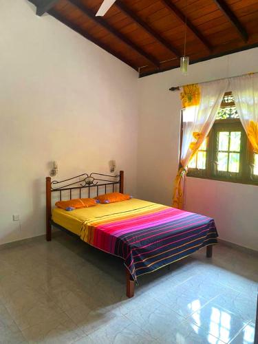 a bedroom with a bed in the corner of a room at Sylt Haus in Beruwala