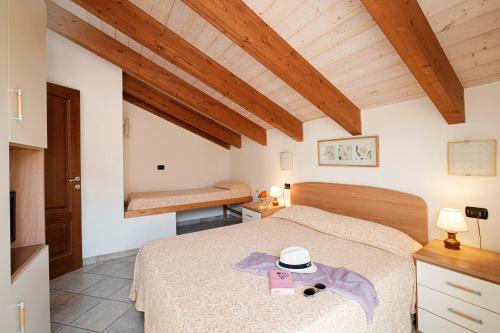 a bedroom with a bed with a hat on it at Appartamenti In Piazzetta in Deiva Marina