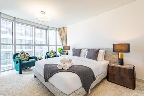 a bedroom with a large bed with a teddy bear on it at Full Sunset Canal Views - Amazing Apartment in the Heart of Al Reem - 5 min from Cleveland, Galleria, ADGM in Abu Dhabi